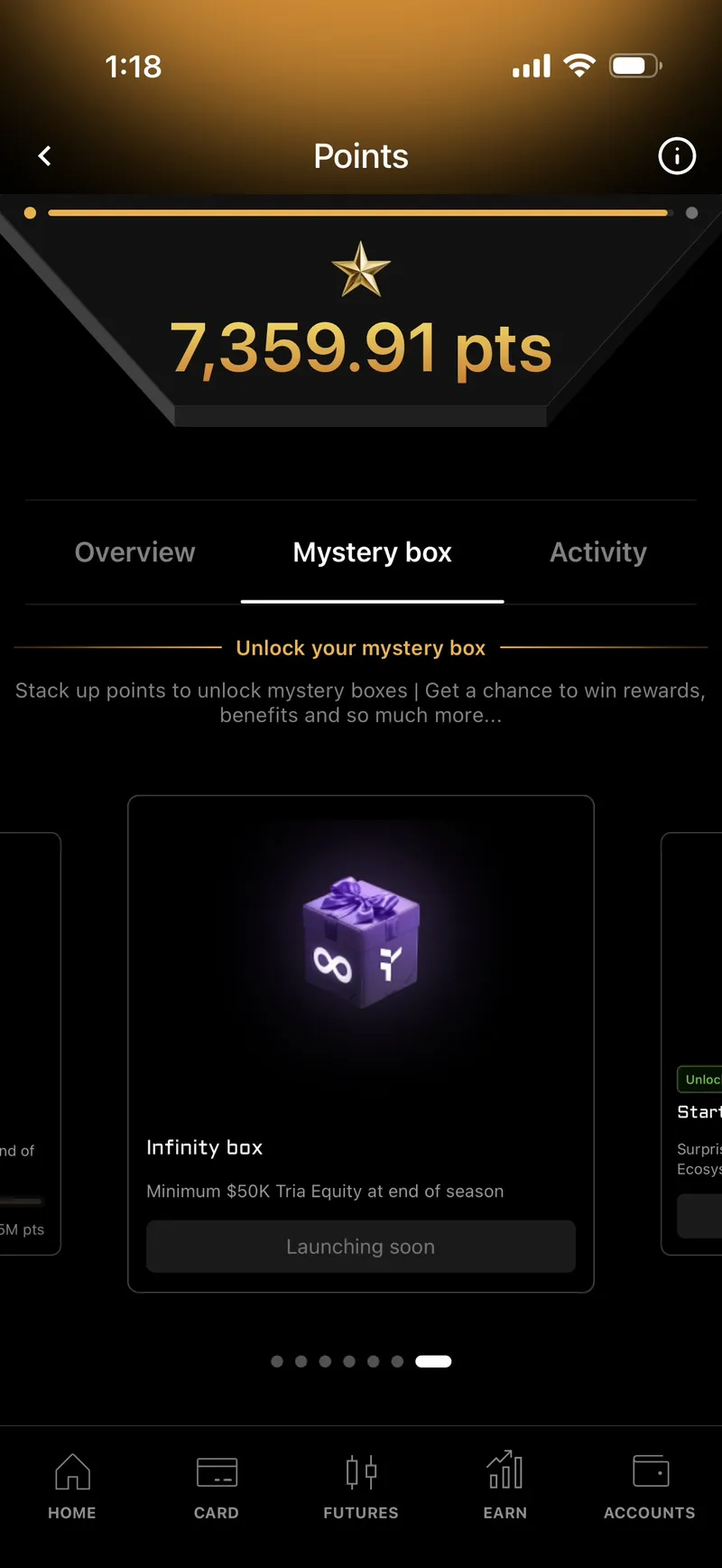 Tria mystery box screen showing the Infinity box requiring a minimum $50K Tria equity at end of season, marked Launching soon